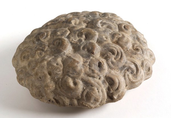 A clay-baked hair style. Roman votive offering