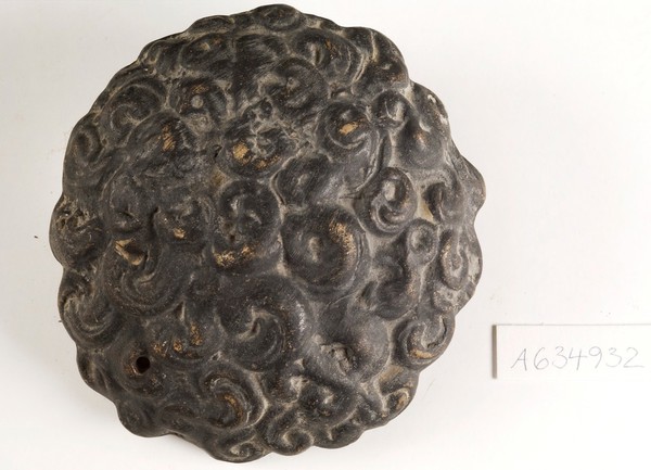 A clay-baked hair style. Roman votive offering