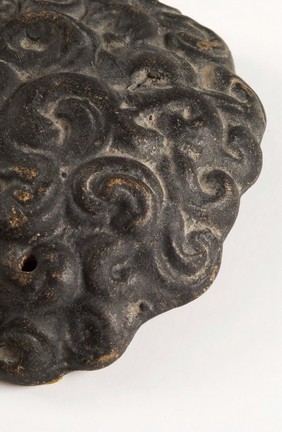 A clay-baked hair style. Roman votive offering
