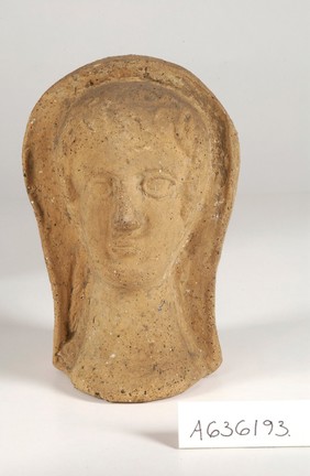 A clay-baked face Roman votive offering