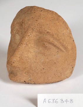 A clay-baked face. Roman votive offering