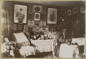 view Nurse Tremlow (name unconfirmed), a monthly nurse to gentry and royal households, in retirement, with photographs of her employers. Photograph, 19--.