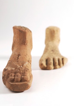 Two clay-baked feet. Roman votive offering
