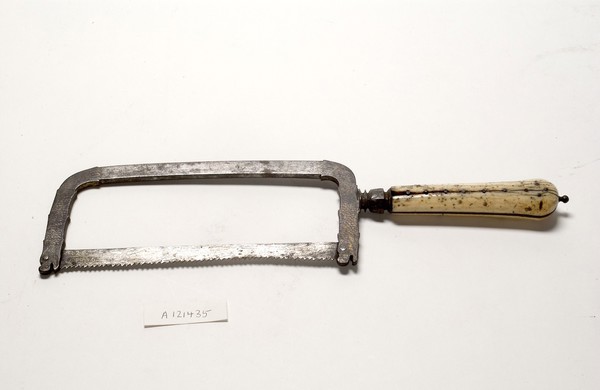 Small bow-frame amputation saw, ornate design on damascened frame, ivory handle, from Hamonic collection.