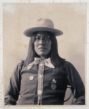 view Assuz, a member of the San Carlos Apache. Platinum print by F.A. Rinehart, 1898.