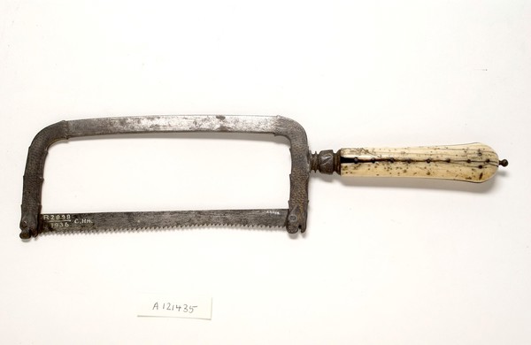 Small bow-frame amputation saw, ornate design on damascened frame, ivory handle, from Hamonic collection.