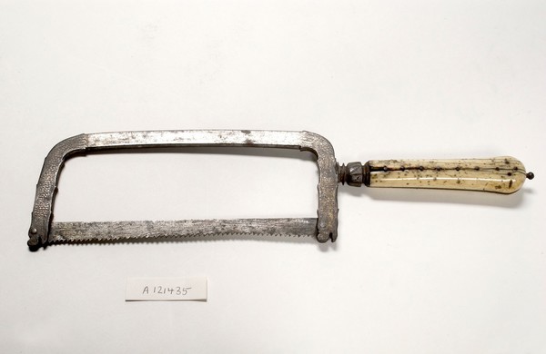 Small bow-frame amputation saw, ornate design on damascened frame, ivory handle, from Hamonic collection.