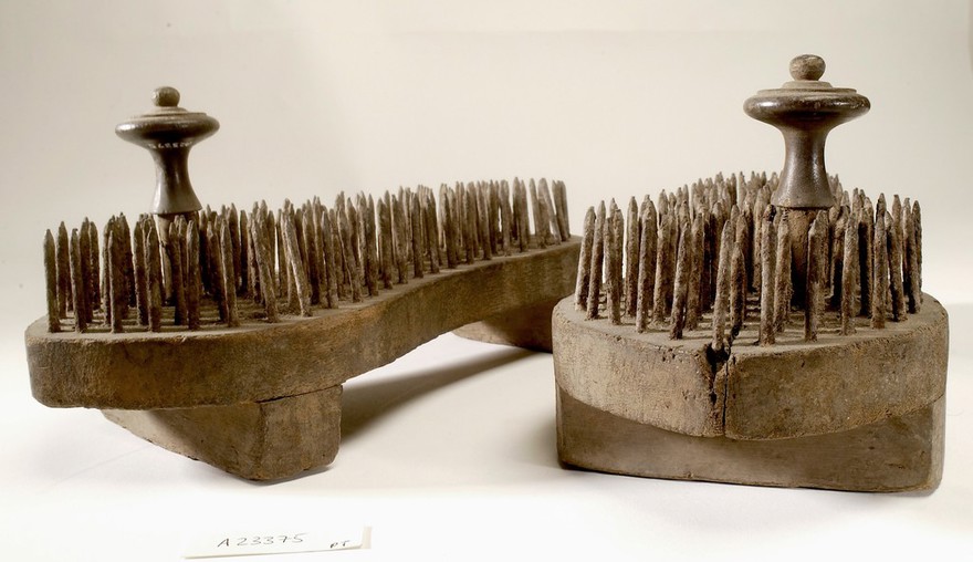 A pair of fakir's sandals with iron spikes.