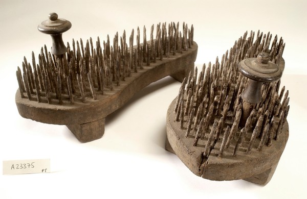 A pair of fakir's sandals with iron spikes.