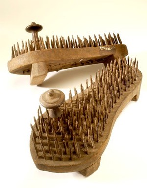 view A pair of fakir's sandals with iron spikes.