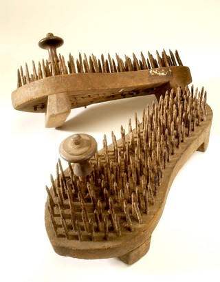 A pair of fakir's sandals with iron spikes.