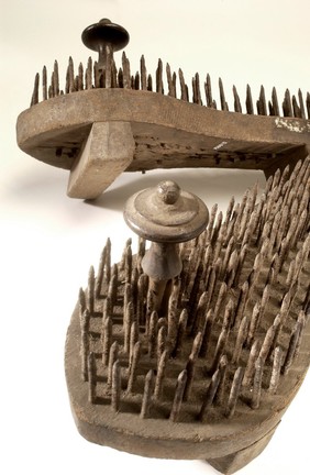 A pair of fakir's sandals with iron spikes.