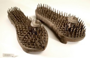 view A pair of fakir's sandals with iron spikes.