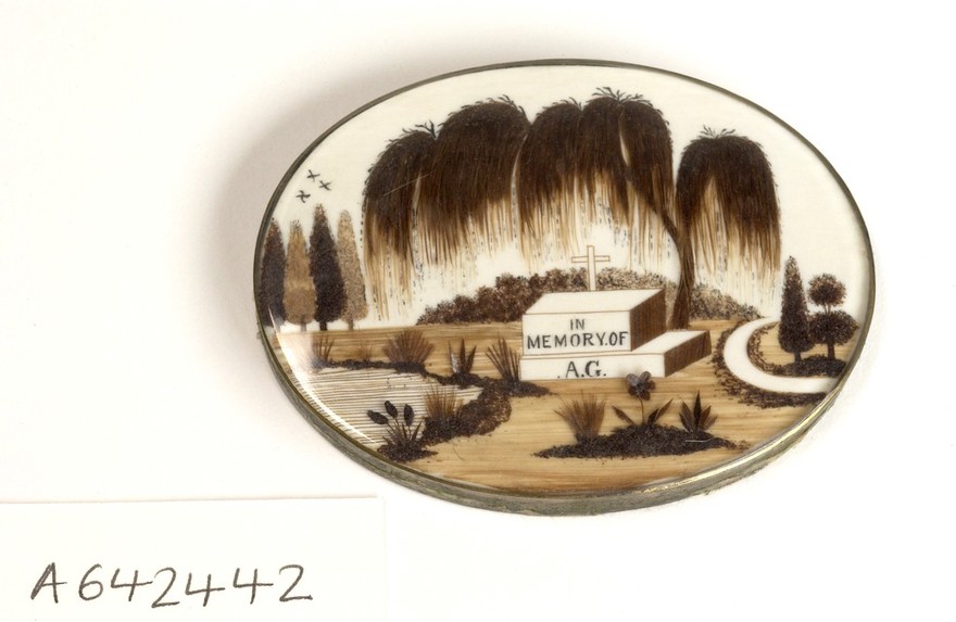 Mourning brooche showing a graveyard scene.