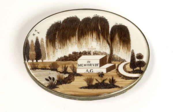 Mourning brooche showing a graveyard scene.