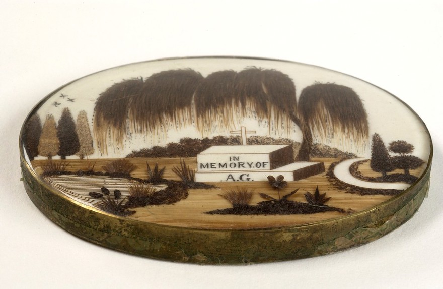 Mourning brooche showing a graveyard scene.