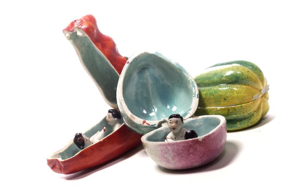 Porcelain fruit containing couple engaged in sexual foreplay