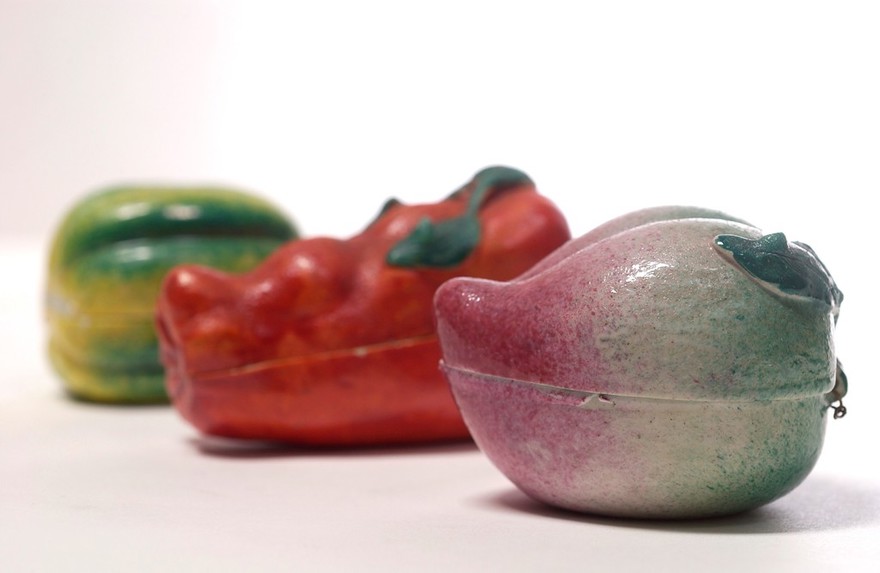 Porcelain fruit containing couple engaged in sexual foreplay