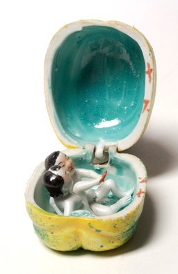 Porcelain fruit containing couple engaged in sexual foreplay