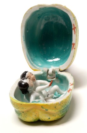 Porcelain fruit containing couple engaged in sexual foreplay