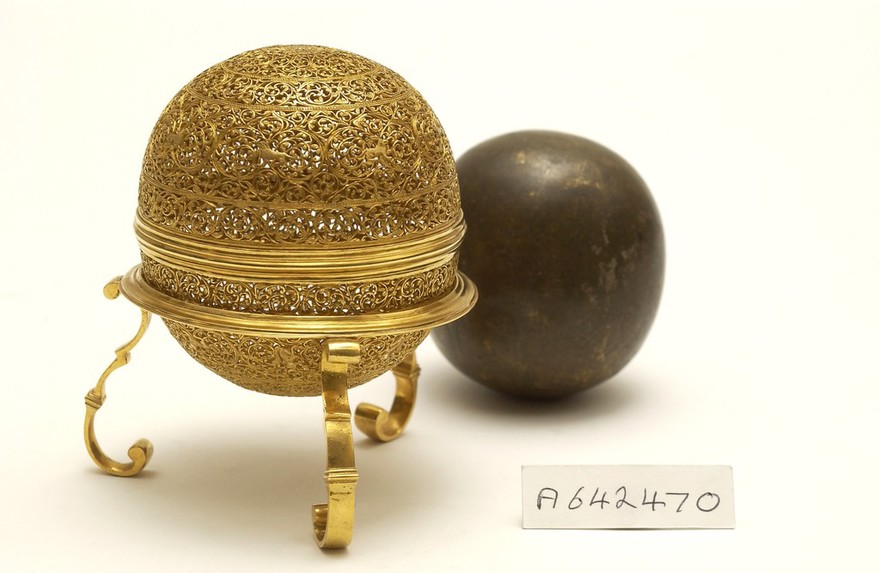 An artificially manufactured version of a goa stone found inside the stomachs of an animal (bezoar stones) and its case. Made in India from a paste of clay, crushed shell, amber, musk and resin and used for numerous complaints such as poisons