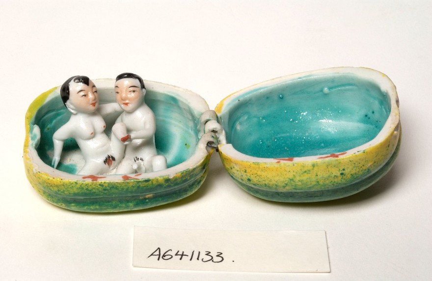 Porcelain fruit containing couple engaged in sexual foreplay