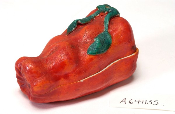 Porcelain fruit containing couple engaged in sexual foreplay