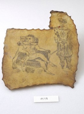 Two tattoos on a piece of human skin showing a seated nude female and a standing male