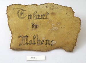 view A tattoo in the form of writing on a piece of human skin, 'Enfant du Malheus'