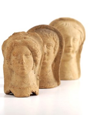 view Three Roman votive offering representing faces
