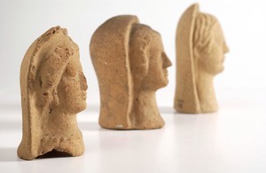 view Three Roman votive offering representing faces