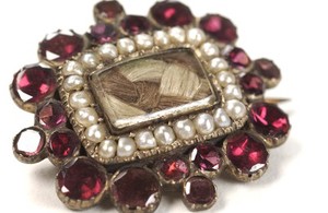 view Mourning brooch containing the hair of a deceased relative.