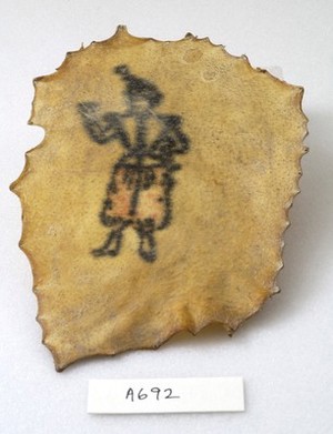 view A tattoo on a piece of human skin showing a small human figure