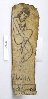 A tattoo on a piece of human skin showing a nude female called Flora