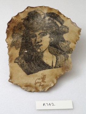 A tattoo on a piece of human skin showing a female face