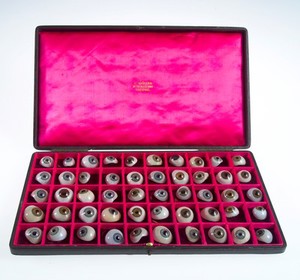 view A case filled with a selection of 50 glass eyes. Possibly made by E. Muller of Liverpool.