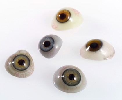 A selection of glass eyes from an opticians glas eye case. Possibly made by E. Muller of Liverpool.