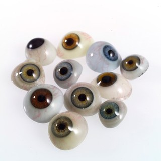 A selection of glass eyes from an opticians glas eye case. Possibly made by E. Muller of Liverpool.