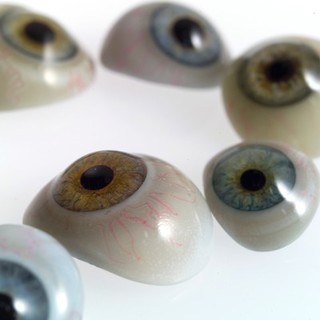 A selection of glass eyes from an opticians glas eye case. Possibly made by E. Muller of Liverpool.