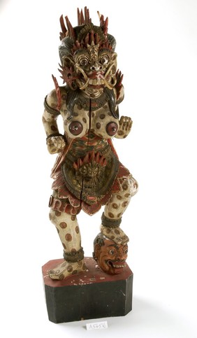 Wooden figure of bare-breasted female demon