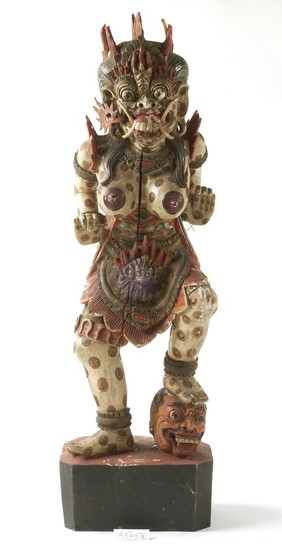 Wooden figure of bare-breasted female demon
