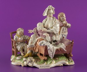 view Porcelain figure of a woman breast feeding a baby