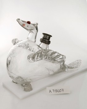 Glass infant's feeding bottle with three legs.