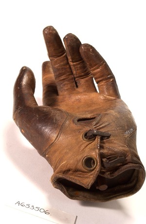 view Artificial left hand, wood with metal wrist plate and leather glove.
