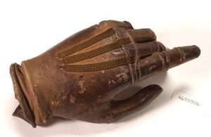 view Artificial left hand, wood with metal wrist plate and leather glove.