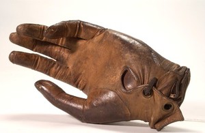 view Artificial left hand, wood with metal wrist plate and leather glove.