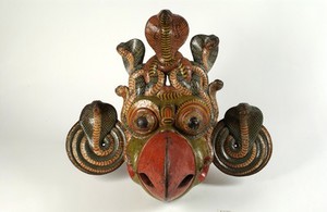 view Painted wooden mask, polychrome, with coiled Cobra disc ear-pieces and Cobra headress representing beaked gurulu rassa from Kolam play, Sinhalese