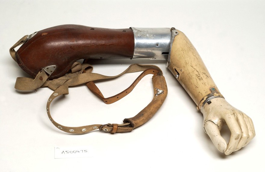 Artificial left arm with shoulder straps. Made with leather and aluminium by W. R. Grossmith.