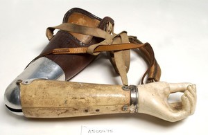 view Artificial left arm with shoulder straps. Made with leather and aluminium by W. R. Grossmith.