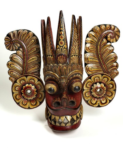 Sri Lankan mask with a demon's face and ear-pieces.